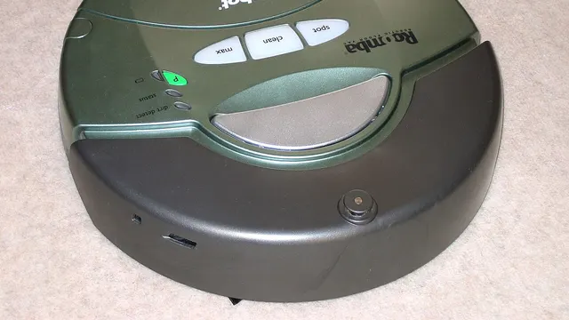 A green robot vacuum cleaner resting on a beige carpet