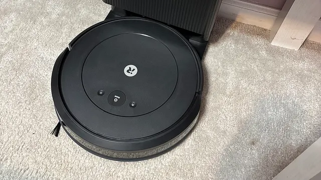 A robot vacuum and mop parked on its charging station