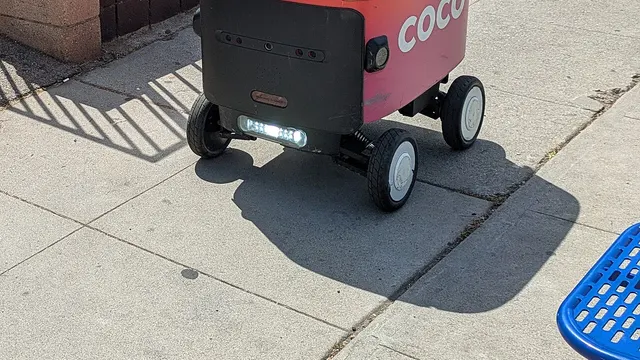 A Coco delivery robot on a sidewalk in Los Angeles