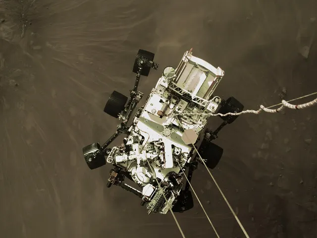 The Perseverance rover suspended beneath its descent stage, above the Martian surface, in February 2021