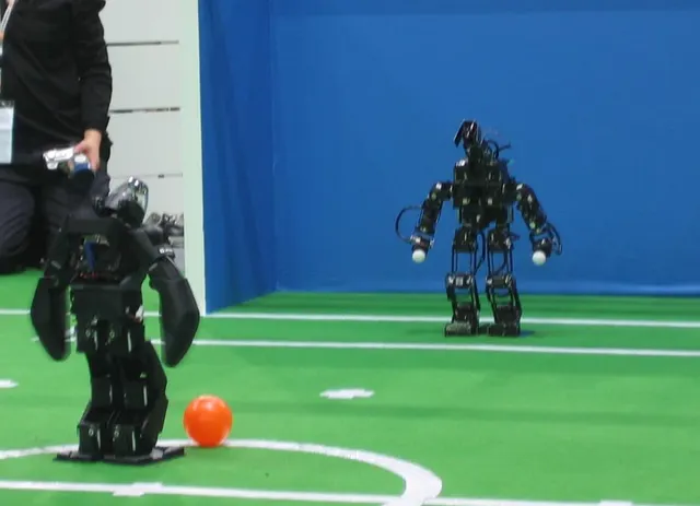 A small bipedal humanoid robot at a RoboCup competition