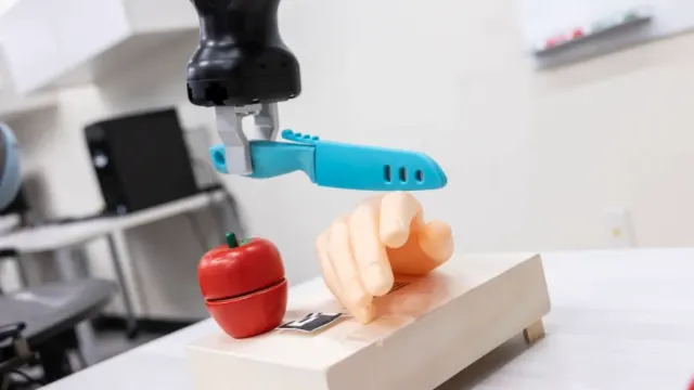 Two letters, "CF", and a robot supposed to cut an apple turns on a plastic hand